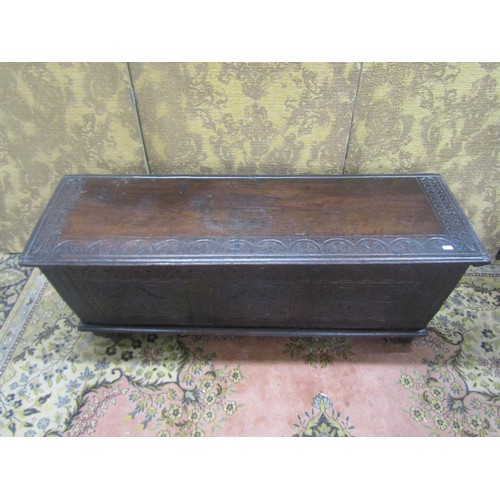 1482 - An antique oak six plank coffer with geometric carved detail finish, 48cm high, 125cm x 40cm