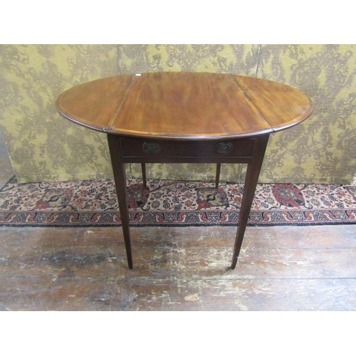 1488 - A Georgian mahogany oval Pembroke table with crossbanding and string inlay incorporating a frieze dr... 