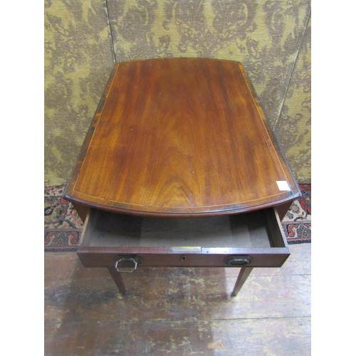 1488 - A Georgian mahogany oval Pembroke table with crossbanding and string inlay incorporating a frieze dr... 