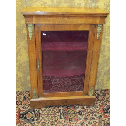 1499 - A 19th century pier cabinet enclosed by a glazed panelled door with applied cast brass fittings on a... 