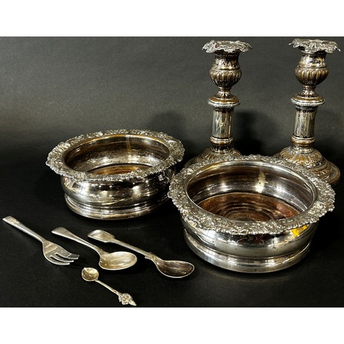 218 - Two silver plated wine coasters and a pair of candlesticks and three spoons and fork (8)