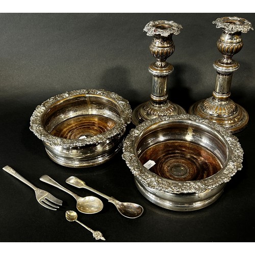 218 - Two silver plated wine coasters and a pair of candlesticks and three spoons and fork (8)