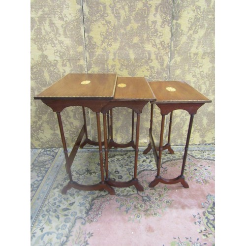 1505 - A nest of three Edwardian mahogany occasional tables in the Georgian style with chequer string borde... 