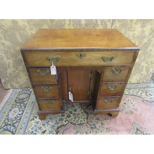 1508 - A George III mahogany kneehole desk of diminutive proportions,  fitted with seven drawers and recess... 