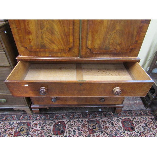 1511 - A William IV mahogany linen press, the lower section enclosed by three long drawers with carved knob... 