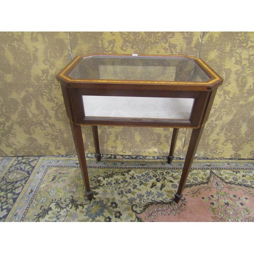 1513 - A small Edwardian style vitrine of rectangular form with canted corners, raised on square taper legs... 