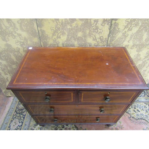 1516 - A 19th century mahogany chest of two long and two short drawers crossbanded in satin wood, on turned... 