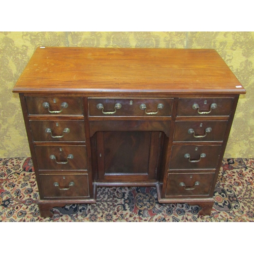 1522 - A George III mahogany kneehole writing desk, the central alcove partially enclosed by a panelled doo... 