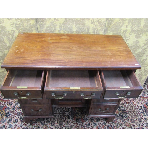 1522 - A George III mahogany kneehole writing desk, the central alcove partially enclosed by a panelled doo... 