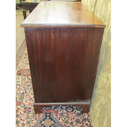 1522 - A George III mahogany kneehole writing desk, the central alcove partially enclosed by a panelled doo... 