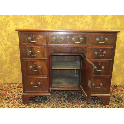 1522 - A George III mahogany kneehole writing desk, the central alcove partially enclosed by a panelled doo... 