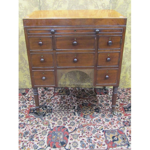 1523 - A 19th century mahogany gentleman's commode with rising lid, the front elevation enclosed by a serie... 