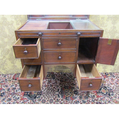 1523 - A 19th century mahogany gentleman's commode with rising lid, the front elevation enclosed by a serie... 