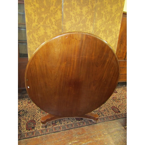 1533 - A large early Victorian mahogany snaptop breakfast table raised on a hexagonal column and large tric... 