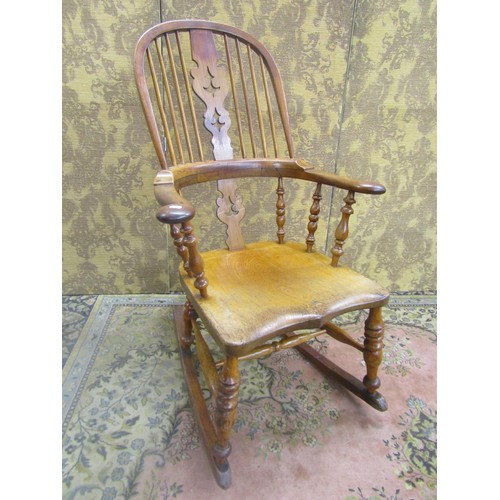 1535 - A 19th century comb back Windsor chair in mixed woods, elm, ash, etc, with pierced splat, stamped to... 