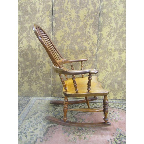 1535 - A 19th century comb back Windsor chair in mixed woods, elm, ash, etc, with pierced splat, stamped to... 