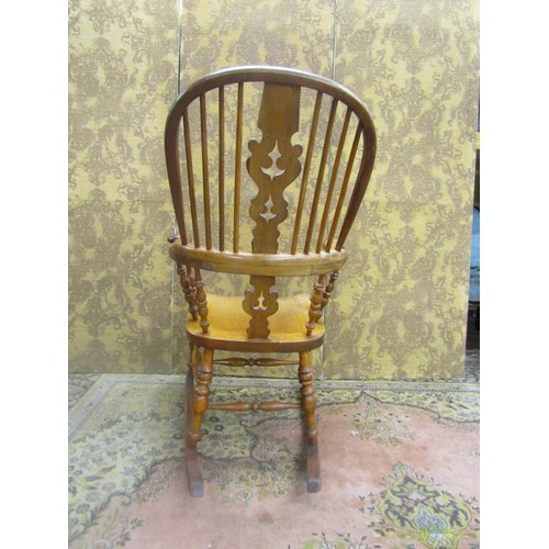 1535 - A 19th century comb back Windsor chair in mixed woods, elm, ash, etc, with pierced splat, stamped to... 