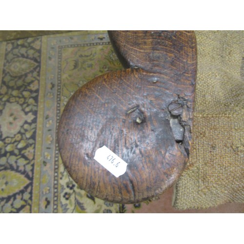 1536 - An 18th century oak lambing chair with fielded panel back and deep winged sides, the shaped arms ove... 