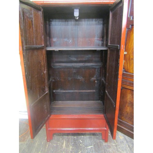 1537 - A decorative Chinese crimson lacquered hanging cupboard of tapering form, 180 cm high, 90cm x 43cm