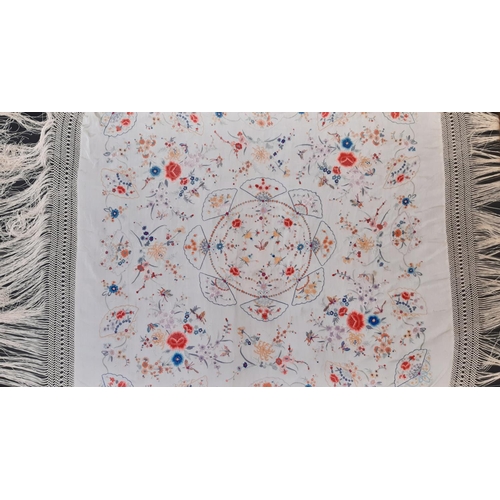 909 - Early 20th century 'Piano' shawl with colourful embroidered flowers and moths on ivory silk ground w... 