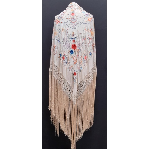 909 - Early 20th century 'Piano' shawl with colourful embroidered flowers and moths on ivory silk ground w... 