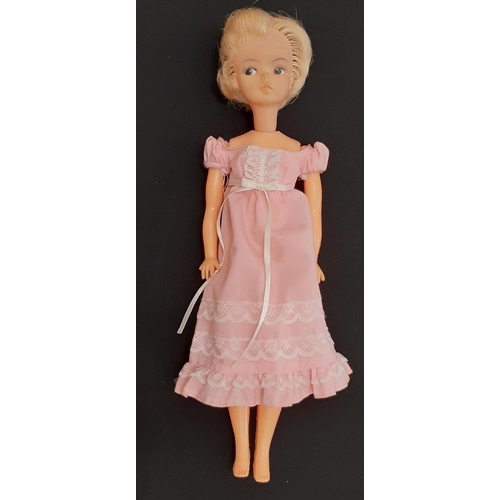 921 - A collection of vintage dolls and accessories including an early 1960's short haired Sindy doll, a U... 