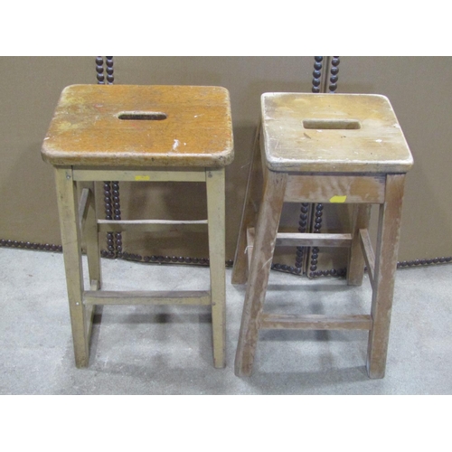 1095 - Two similar vintage stained beechwood ex lab/school stools with square cut supports and rails