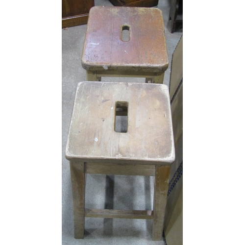 1095 - Two similar vintage stained beechwood ex lab/school stools with square cut supports and rails