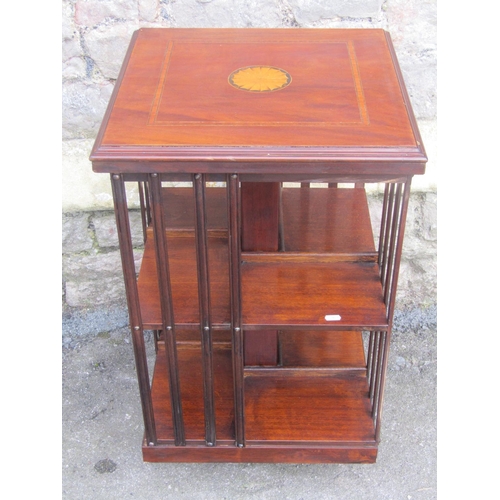 1140 - An inlaid mahogany floorstanding revolving bookcase of usual square cut form, 78 cm high x 48 cm squ... 