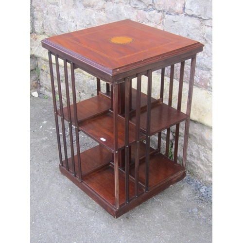 1140 - An inlaid mahogany floorstanding revolving bookcase of usual square cut form, 78 cm high x 48 cm squ... 