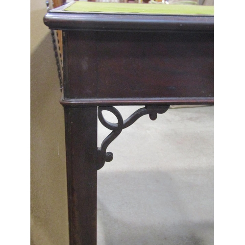 1141 - A Georgian mahogany fold over top  card table of rectangular form raised on square cut and moulded s... 