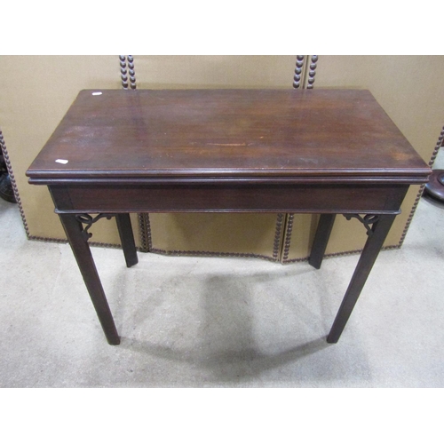 1141 - A Georgian mahogany fold over top  card table of rectangular form raised on square cut and moulded s... 