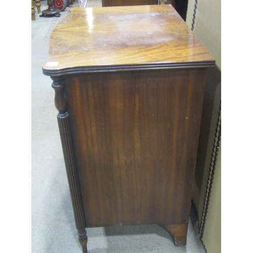 1146 - A small reproduction mahogany bow front chest in the Georgian style of four long drawers flanked by ... 