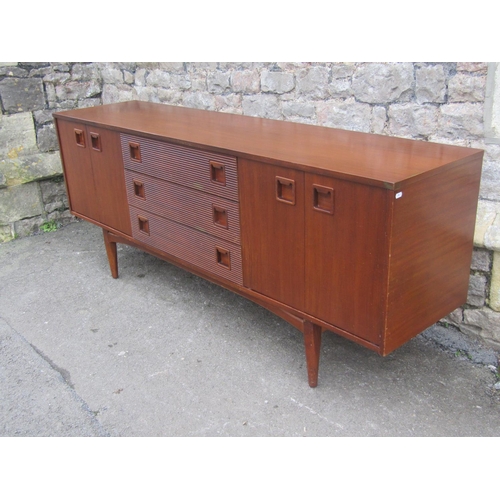 1150 - A Mid 20th century long and low teak sideboard by Elliotts of Newbury, partially enclosed by side cu... 