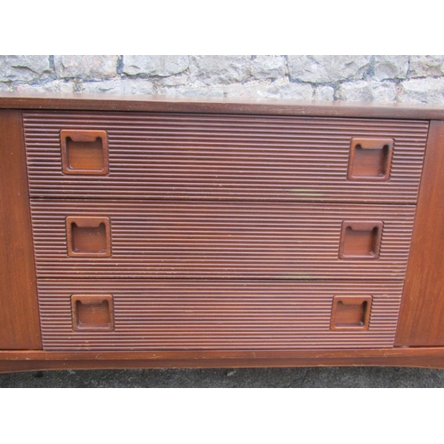 1150 - A Mid 20th century long and low teak sideboard by Elliotts of Newbury, partially enclosed by side cu... 