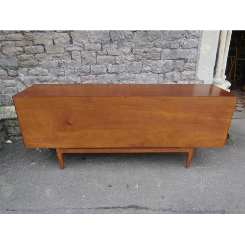 1150 - A Mid 20th century long and low teak sideboard by Elliotts of Newbury, partially enclosed by side cu... 