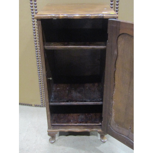 1168 - An Edwardian walnut pedestal side cupboard enclosed by a rectangular moulded panelled door set on sh... 