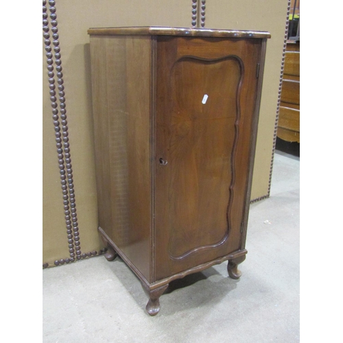 1168 - An Edwardian walnut pedestal side cupboard enclosed by a rectangular moulded panelled door set on sh... 