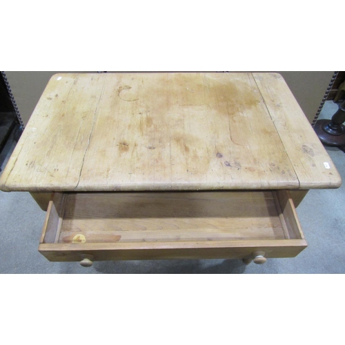 1172 - A stripped pine kitchen table, the rectangular top with moulded outline over a frieze drawer and tur... 