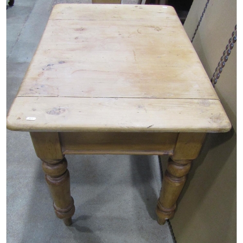 1172 - A stripped pine kitchen table, the rectangular top with moulded outline over a frieze drawer and tur... 