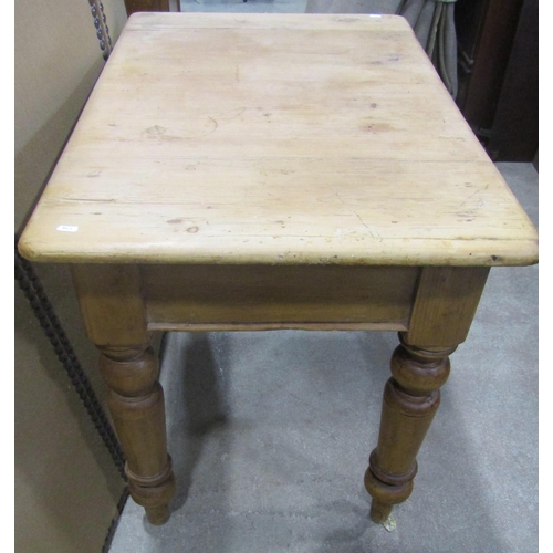 1172 - A stripped pine kitchen table, the rectangular top with moulded outline over a frieze drawer and tur... 