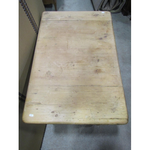 1172 - A stripped pine kitchen table, the rectangular top with moulded outline over a frieze drawer and tur... 