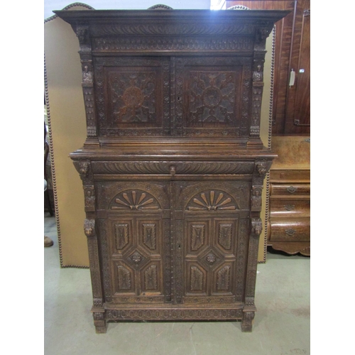 1177 - A Victorian gothic oak two sectional side cupboard in the old English style, the front elevation enc... 