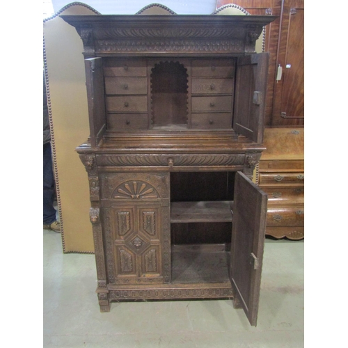 1177 - A Victorian gothic oak two sectional side cupboard in the old English style, the front elevation enc... 