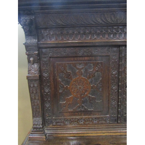 1177 - A Victorian gothic oak two sectional side cupboard in the old English style, the front elevation enc... 