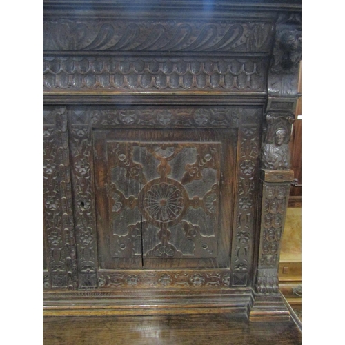 1177 - A Victorian gothic oak two sectional side cupboard in the old English style, the front elevation enc... 