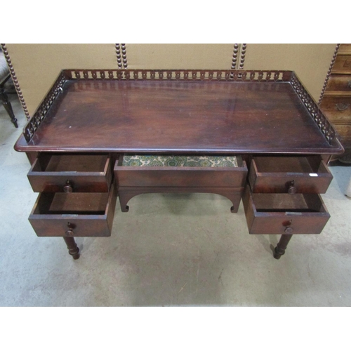 1194 - A 19th century mahogany side/dressing table with raised three quarter pierced gallery over an arrang... 