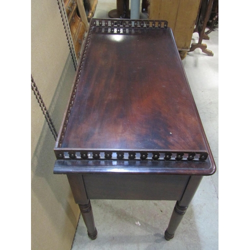 1194 - A 19th century mahogany side/dressing table with raised three quarter pierced gallery over an arrang... 