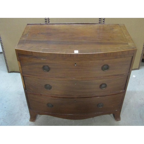 1196 - An early 19th century mahogany caddy top bow fronted bedroom chest of three long graduated drawers w... 