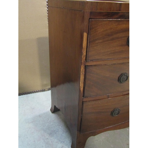 1196 - An early 19th century mahogany caddy top bow fronted bedroom chest of three long graduated drawers w... 